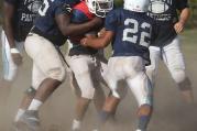 Players converge on quarterback during football practice at Maryland Catholic high school. (CNS photo /Bob Roller) 