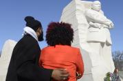 Couple pauses at Martin Luther King Jr. Memorial in Washington.