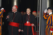 Swiss Guards salute as Cardinals Timothy M. Dolan of New York and Daniel N. DiNardo of Galveston-Houston leave a meeting of cardinals with Pope Francis in the synod hall at the Vatican Feb. 21, 2014. (CNS photo/Paul Haring) 