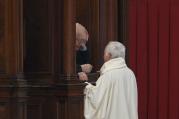 Priest hears confession of clergy member in St. Peter's Basilica at Vatican. (CNS photo/Paul Haring)