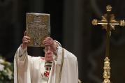 Pope Francis raises the Book of the Gospels as he celebrates the Easter Vigil in St. Peter's Basilica at the Vatican April 19. (CNS photo/Paul Haring) 