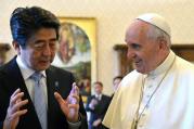 Japanese Prime Minister Shinzo Abe gestures as he speaks to Pope Francis while exchanging gifts during private audience at Vatican in June 2014.