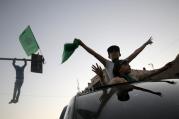 Palestinians celebrate a cease-fire in Gaza City Aug. 26. Catholic aid officials say they hope the Egyptian-brokered Israeli-Hamas cease-fire proposal will hold. (CNS photo/Mohammed Saber, EPA)