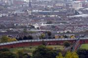 A section of the Peace Wall that divides Catholic and Protestant communities cuts its way through West Belfast, Northern Ireland. (CNS photo/Cathal McNaughton, Reuters)