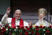 Pope Francis and Ecumenical Patriarch Bartholomew of Constantinople greet a small crowd after delivering a blessing in Istanbul Nov. 30. (CNS photo/Paul Haring) 