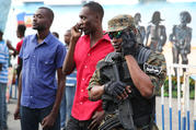 A police officer stands guard during Carnival celebrations in Port-au-Prince, Haiti, in February 2015. (CNS photo/Bob Roller)