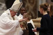 Pope Francis greets children in offertory procession at Holy Thursday chrism Mass in St. Peter's Basilica at Vatican.