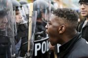 A demonstrator confronts police near Camden Yards during a march to protest the death of Freddie Gray in Baltimore April 25. (CNS photo/Sait Serkan Gurbuz, Reuters)