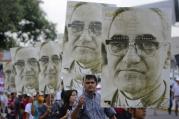 People carry portraits of Salvadoran Archbishop Oscar Romero during rally in his honor in San Salvador.
