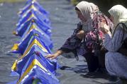 Thousands of Bosnians attended the funeral for 10 Muslims who were killed by Serb forces at the beginning of the country's 1992-95 war. Their remains were later found and identified in mass graves.