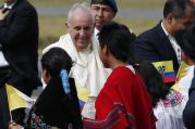Pope Francis greets children in traditional dress as he arrives at Mariscal Sucre International Airport in Quito, Ecuador, July 5. The pope is making an eight-day trip to Ecuador, Bolivia and Paraguay. (CNS photo/Paul Haring)