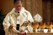 Archbishop Blase J. Cupich of Chicago swings a censer over the altar during an Aug. 23 Mass at Holy Name Cathedral in Chicago where he received the pallium. (CNS photo/Karen Callaway, Catholic New World)