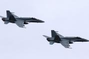 In this May 31, 2014, file photo, two Royal Canadian Air Force F-18 Hornet jets fly over Romania. Canada's new government has decided to stop airstrikes against Islamic State in the Middle East. (CNS photo/Mircea Rosca, EPA)