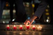 People light candles in tribute to the victims of the Paris attacks, outside the French Embassy in Berlin, Germany, Nov. 13. Dozens of people were killed in a series of attacks in Paris Nov. 13. (CNS photo/Lukas Schulze, EPA) 