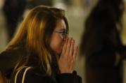 A woman mourns in Republique square in Paris Nov. 14 as people gather in memory of victims of terrorist attacks. Coordinated attacks the previous evening claimed the lives of 129 people. The Islamic State claimed responsibility. (CNS photo/Paul Haring) 