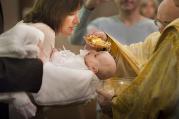 Oksana Vydash holds on to her goddaughter Veronika Victoria Shalai during her baptism at St. Mary's Assumption Ukrainian Catholic Church in St. Louis in this Jan. 12, 2013, file photo. (CNS photo/Lisa Johnston, St. Louis Review) 