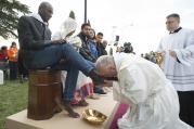 Pope Francis kisses the foot of a refugee during Holy Thursday Mass of the Lord's Supper at the Center for Asylum Seekers in Castelnuovo di Porto, about 15 miles north of Rome in March 2016. The pope washed and kissed the feet of refugees, including Muslims, Hindus and Copts. (CNS photo/L'Osservatore Romano, handout)