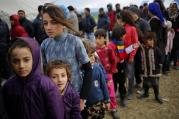 Young refugees wait in line for tea at a makeshift camp April 11 at the Greek-Macedonian border near the village of Idomeni, Greece. Pope Francis will travel to Lesbos, Greece, April 16. (CNS photo/Stoyan Nenov, Reuters) 