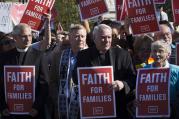 Representatives of faith-based groups gather outside the U.S. Supreme Court in Washington on April 18 as the justices hear oral arguments in a challenge by several states to President Barack Obama's deferred deportation programs. (CNS photo/Tyler Orsburn)