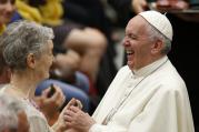 Pope Francis laughs as he greets a woman during an audience with people from Lyon, France, in Paul VI hall at the Vatican July 6. The audience was with 200 people living in difficult or precarious situations. (CNS photo/Paul Haring) 
