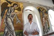 Giammarco Piacenti, CEO of the Piacenti restoration center, stands in front of angel mosaics in the Church of the Nativity July 5 in Bethlehem, West Bank. Restoration specialists from the center completed their work in June. (CNS photo/CNS/Debbie Hill)
