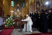 Pope Francis signs a guest book after praying at the Shrine of Divine Mercy in Lagiewniki, a suburb of Krakow, Poland, on July 30. (CNS photo/L'Osservatore Romano) 