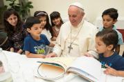 Pope Francis sits with refugee children from Syria at the Vatican Aug. 11. (CNS photo/L'Osservatore Romano via Reuters) 