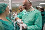 House of Mercy. Pope Francis holds a baby as he visits the neonatal unit at San Giovanni Hospital in Rome Sept. 16. The visit was part of the pope's series of Friday works of mercy during the Holy Year. (CNS photo/L'Osservatore Romano, handout)