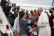Pope Francis greets Syrian refugees he brought to Rome from the Greek island of Lesbos in April 2016 at Ciampino airport in Rome. (CNS photo/Paul Haring) 