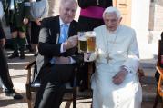 Retired Pope Benedict XVI enjoys a beer during his his 90th birthday celebration April 17 at the Vatican. (CNS photo/L'Osservatore Romano)