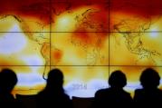 Participants look at a screen showing a world map with climate anomalies during the World Climate Change Conference at Le Bourge, France, in this Dec. 8, 2015, file photo. (CNS photo/Stephane Mahe, Reuters)