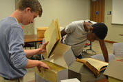 Gonzaga College High School students look through the archives in late June at Georgetown University in Washington. Gonzaga history teacher Ed Donnellan and six students searched through the archives to unearth any ties to slavery at the Jesuit-run high school. (CNS photo/courtesy Gonzaga College High School)