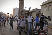 People celebrate Nov. 21 outside parliament after hearing that President Robert Mugabe resigned in Harare, Zimbabwe. All Zimbabweans should have a voice in the country's governance following Mugabe's 37-year presidency, and the new government should embrace diversity, Zimbabwe's bishops said. (CNS photo/Kim Ludbrook, EPA)