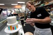 Baker Jack Phillips decorates a cake in his Masterpiece Cakeshop Sept. 21 in Lakewood, Colo. The Supreme Court was set to hear oral arguments Dec. 5 in the case of the baker who cited religious freedom in his refusal to design a wedding cake for a same-sex couple. (CNS photo/Rick Wilking, Reuters)