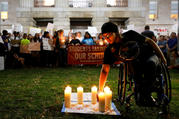 A student lights a candle in front of the North Carolina Capitol in Raleigh on Feb. 20 in memory of the victims of the shooting at Marjory Stoneman Douglas High School in Parkland, Fla. The students were calling for safer gun laws after 17 people were killed when 19-year-old former student Nikolas Cruz stormed the Parkland school on Feb. 14 with an AR-15 semi-automatic style weapon. (CNS photo/Jonathan Drake, Reuters)