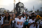 A man carries an image of Blessed Oscar Romero during a March 18 procession in San Salvador, El Salvador, to commemorate the 38th anniversary his murder. Pope Francis has cleared the way for the canonization of Blessed Romero, who was shot and killed March 24, 1980, as he celebrated Mass. (CNS photo/Jose Cabezas, Reuters)