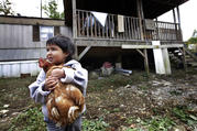 A boy holds a family chicken outside his home in Steele, Ala., in this 2013 file photo. (CNS photo/Karen Callaway, Catholic New World) 