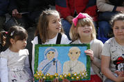 Children hold a gift showing St. Teresa of Kolkata and Pope Francis before the pope's visit to the Mother Teresa Memorial in Skopje, North Macedonia, May 7, 2019. (CNS photo/Paul Haring)