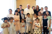 Pope Francis poses during an audience with a delegation from the Institute of the Innocents, a Florence-based organization dedicated to caring for children. The pope met the delegation at the Vatican May 24, 2019, during an audience marking the 600th anniversary of the Italian institute. (CNS photo/Vatican Media)