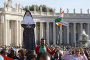 A man holds a life-size cutout of new St. Mariam Thresia Chiramel Mankidiyan of India before the canonization Mass for five new saints celebrated by Pope Francis in St. Peter's Square at the Vatican on Oct. 13. (CNS photo/Paul Haring)