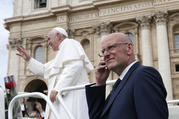 Domenico Giani, lead bodyguard for Pope Francis and head of the Vatican police force, keeps watch as the pope leaves his general audience in St. Peter's Square at the Vatican May 1, 2019. Pope Francis accepted the resignation of Giani Oct. 14, nearly two weeks after an internal security notice was leaked to the Italian press. (CNS photo/Paul Haring)