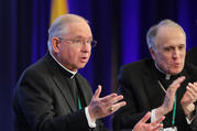 Cardinal Daniel N. DiNardo of Galveston-Houston, president of the U.S. Conference of Catholic Bishops, right, applauds as Archbishop Jose H. Gomez of Los Angeles acknowledges the applause after being named the new president during the fall general assembly of the USCCB in Baltimore Nov. 12, 2019. (CNS photo/Bob Roller) 