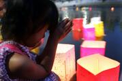 A girl prays after releasing a paper lantern on the Motoyasu River facing the gutted Atomic Bomb Dome in Hiroshima, Japan, Aug 6, 2020, the 75th anniversary of the U.S. dropping the atomic bomb on Hiroshima. (CNS photo/Yuriko Nakao, Reuters)