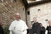 Pope Francis greets religious as he leaves the hermitage and cell of St. Francis in Assisi, Italy, in this Oct. 4, 2013, file photo. The pope plans to visit Assisi on Oct. 3 to celebrate a private Mass and sign his new encyclical on human fraternity. (CNS photo/Paul Haring)