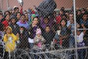 Central American migrants are seen inside an enclosure in El Paso, Texas