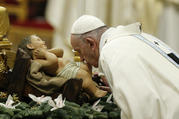 Pope Francis kisses a figurine of the baby Jesus at the start of Mass on the feast of Mary, Mother of God, in St. Peter's Basilica at the Vatican Jan. 1, 2020. (CNS photo/Paul Haring) 