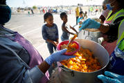  Children wait in line for food at a school near Cape Town, South Africa, May 4, 2020, during the COVID-19 pandemic. (CNS photo/Mike Hutchings, Reuters) 