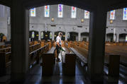 Mike Decker of Nashville, Tenn., applies an electrostatic disinfectant at Christ the King Church May 15, 2020. Bishop J. Mark Spalding has reinstated the public celebration of Mass in the diocese at the discretion of pastors, effective May 18. (CNS photo/Rick Musacchio, Tennessee Register)