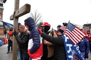  Supporters of President Donald Trump join in prayer outside the U.S. Capitol in Washington Jan. 6, 2021, where U.S. Congress will meet in joint session to certify the Electoral College vote for President-elect Joe Biden. (CNS photo/Mike Theiler, Reuters)