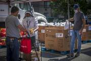 Sister Romana Uzodimma, a Sister of the Handmaids of the Holy Child Jesus, distributes food at Catholic Charities' Spanish Catholic Center in Washington on July 15, 2020. (CNS photo/Chaz Muth)
